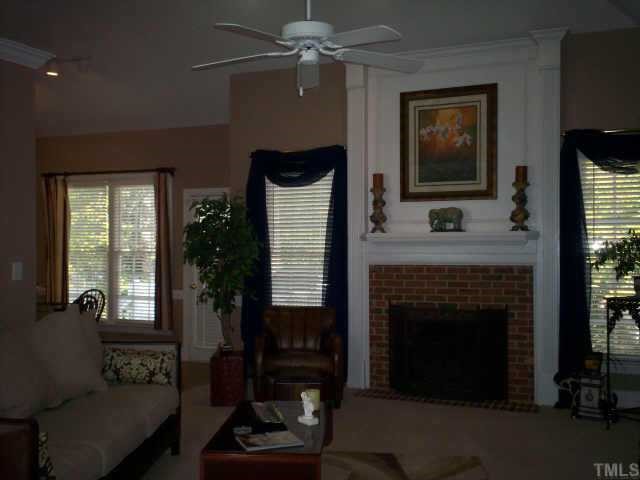 629 Sarah Lawrence Court Raleigh, NC 27609 - Photo 3 of 12 Family rm, vaulted ceiling, fan, gas logs in masonry fireplace