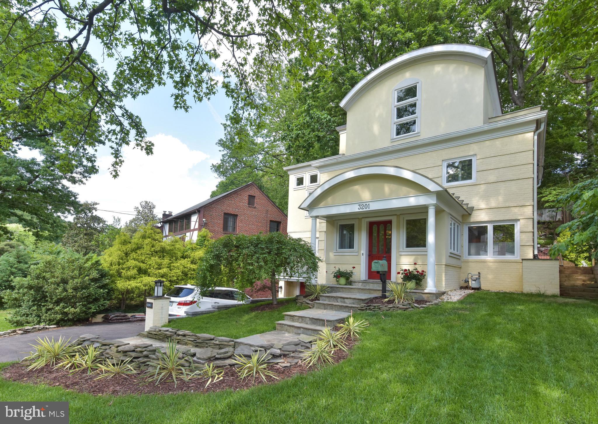 3201 Russell Road Alexandria, VA 22305 - Photo 1 of 60 a front view of a house with a yard and garage