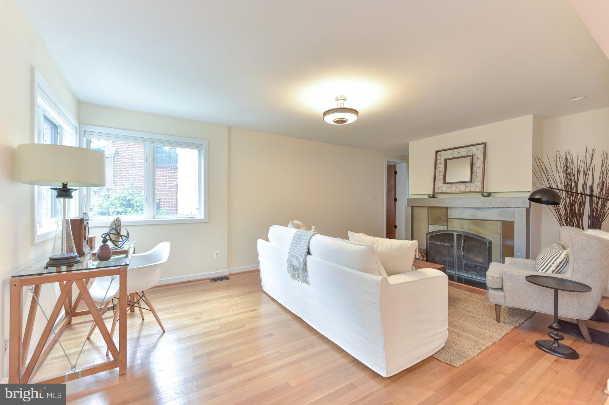 3201 Russell Road Alexandria, VA 22305 - Photo 5 of 60 a living room with furniture a fireplace and a table