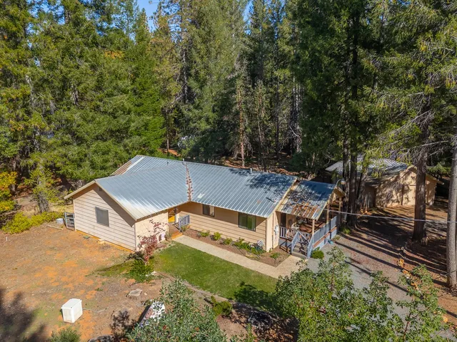 an aerial view of a house with a yard