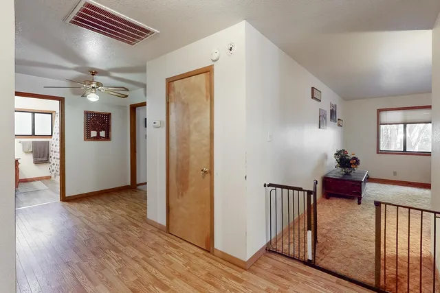 a view of a livingroom with wooden floor and stairs