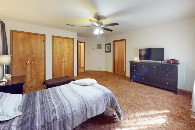 a bedroom with a bed and a chandelier