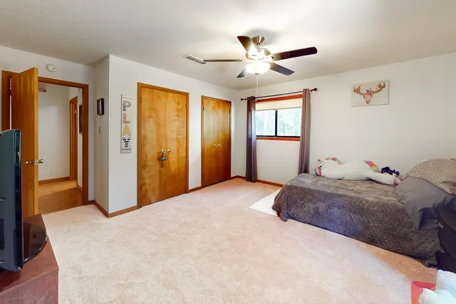 a bedroom with a large bed and a chandelier