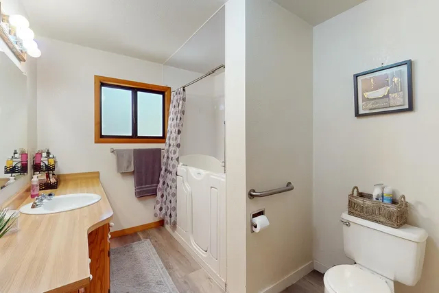 a bathroom with a toilet a sink and a mirror