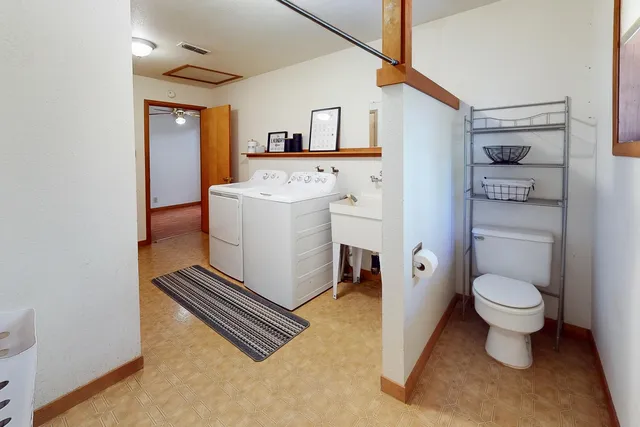 a view of bathroom with a toilet sink and mirror