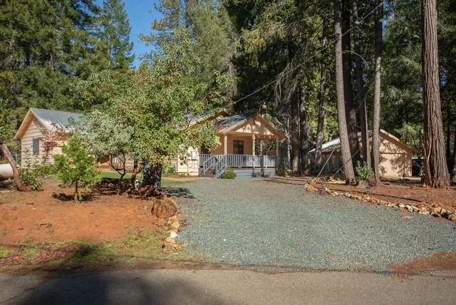a backyard of a house with table and chairs