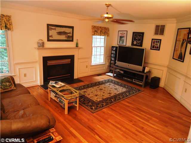 12600 Queensgate Road Midlothian, VA 23114 - Photo 3 of 7 a living room with furniture a flat screen tv and a fireplace