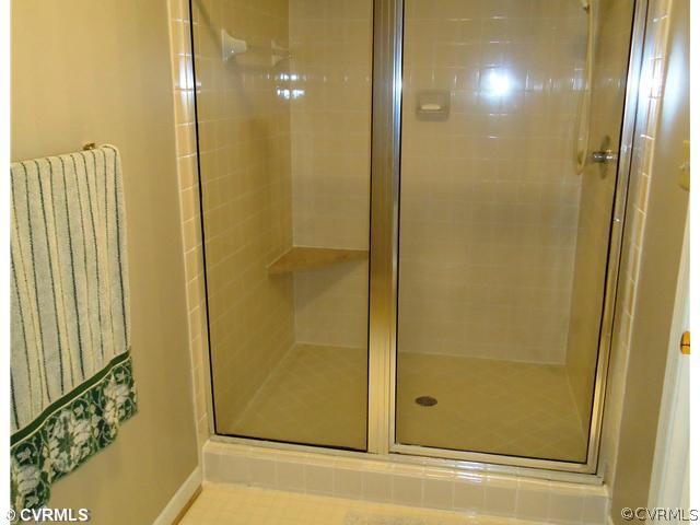 12600 Queensgate Road Midlothian, VA 23114 - Photo 5 of 7 a bathroom with a glass shower door