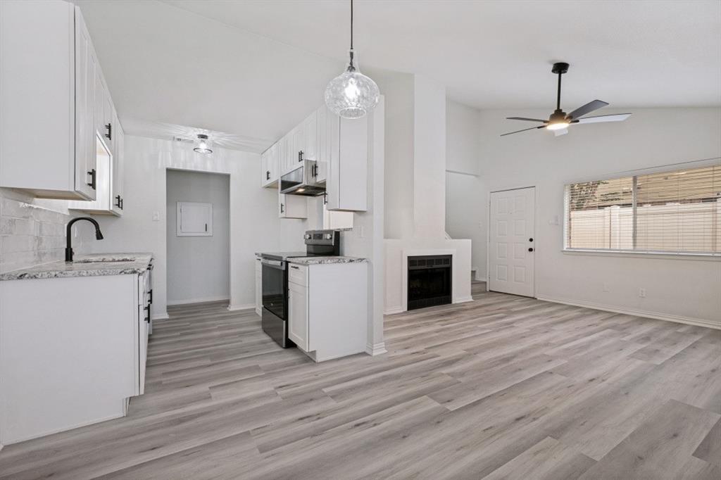 2240 Tarpley Road, Unit 92 Carrollton, TX 75006 - Photo 8 of 22 a view of a kitchen with a sink wooden floor and a window