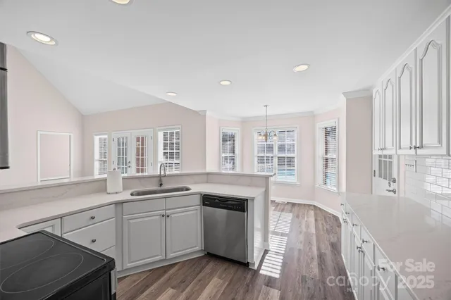 a kitchen with granite countertop a sink and steel appliances