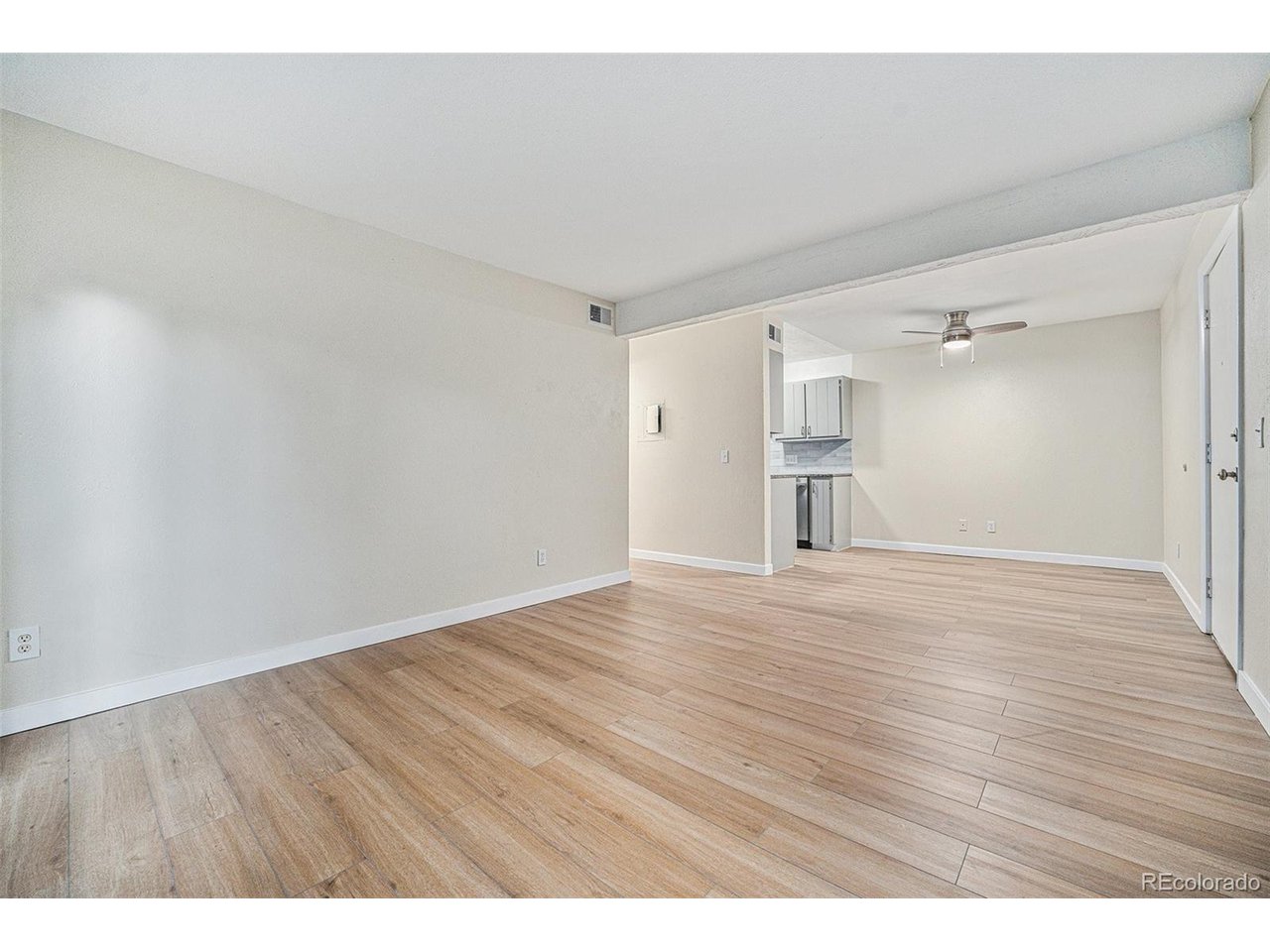16259 West 10th Avenue, Unit K Golden, CO 80401 - Photo 11 of 24 a view of an empty room with wooden floor and a window
