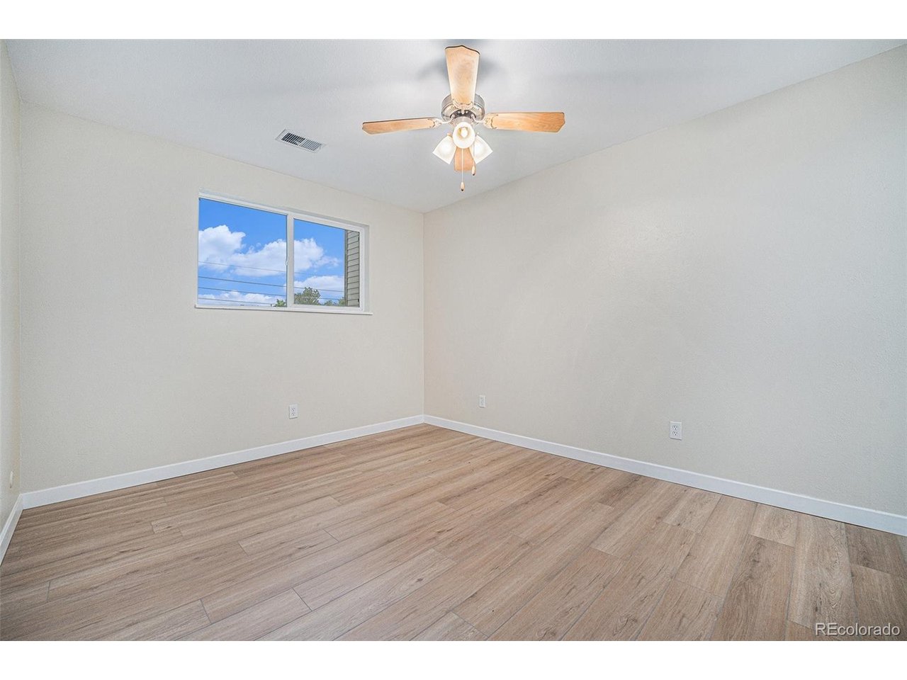16259 West 10th Avenue, Unit K Golden, CO 80401 - Photo 12 of 24 a view of an empty room with wooden floor