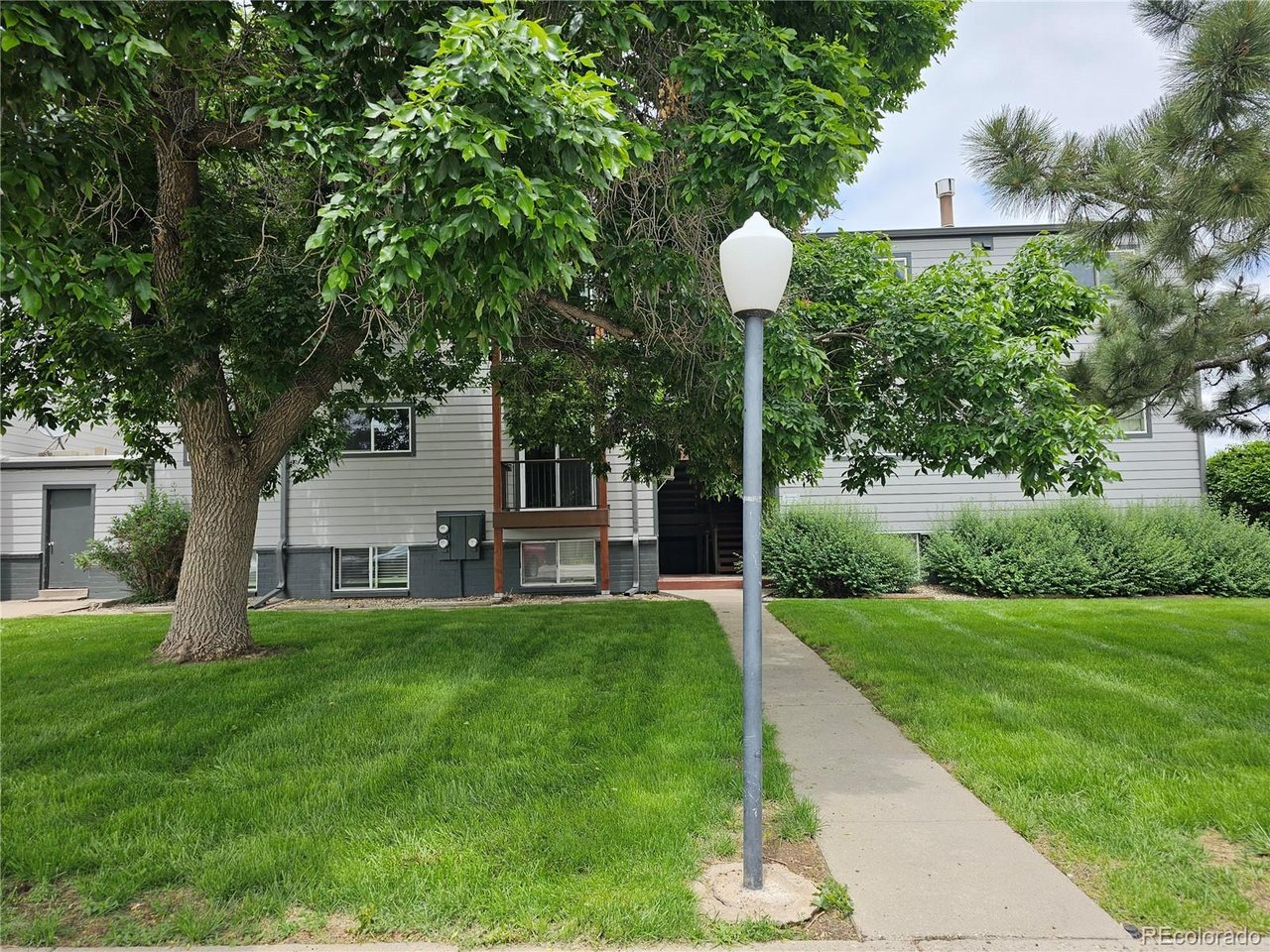 16259 West 10th Avenue, Unit K Golden, CO 80401 - Photo 15 of 24 a view of a house with a backyard and a tree