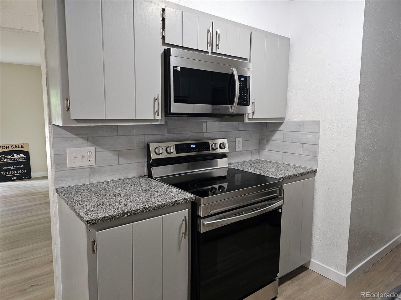 16259 West 10th Avenue, Unit K Golden, CO 80401 - Photo 3 of 24 a kitchen with a stove and a microwave