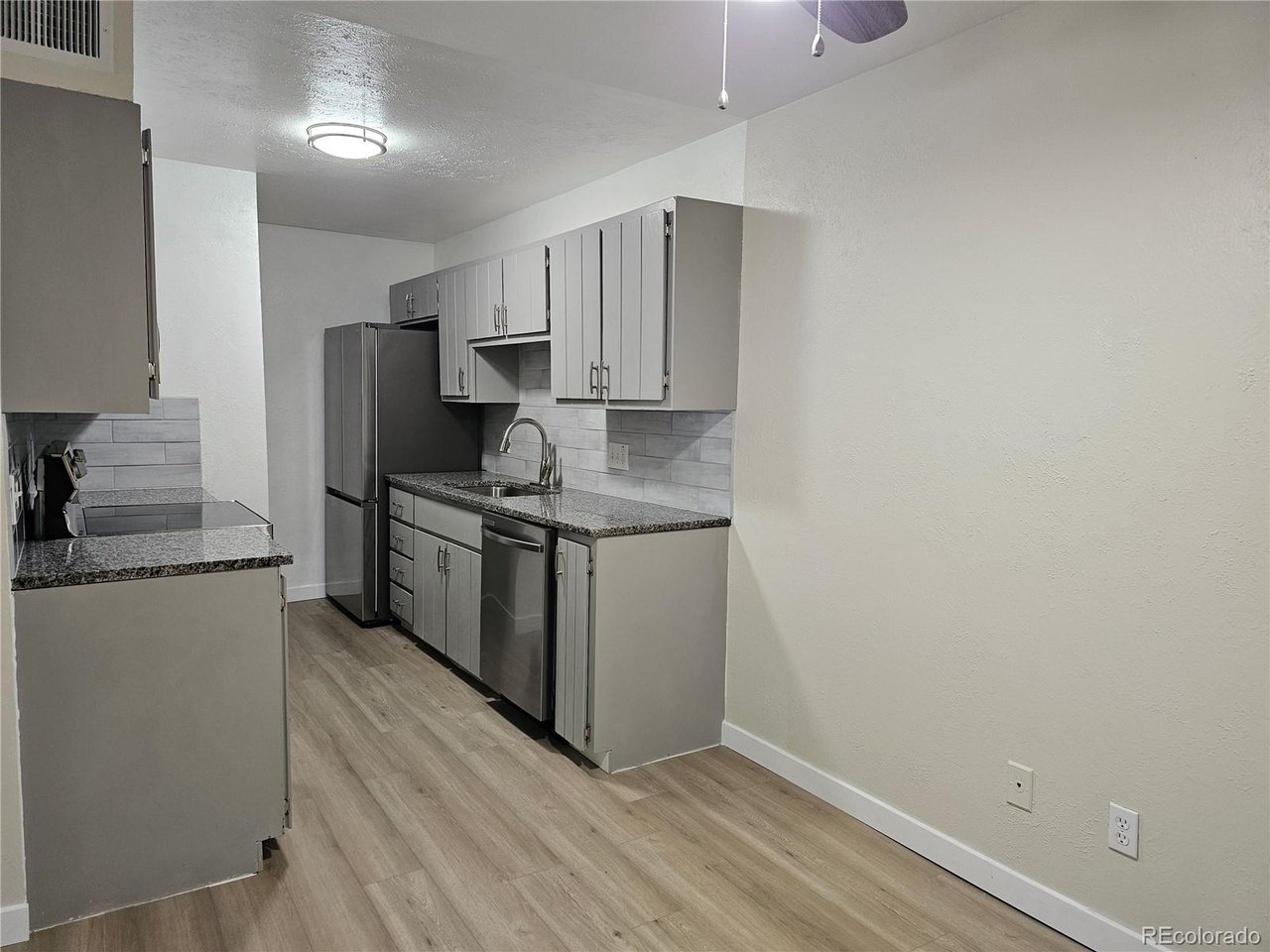 16259 West 10th Avenue, Unit K Golden, CO 80401 - Photo 4 of 24 a kitchen with stainless steel appliances a sink stove and refrigerator
