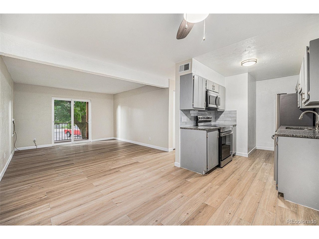 16259 West 10th Avenue, Unit K Golden, CO 80401 - Photo 5 of 24 a kitchen with granite countertop a stove top oven and cabinets