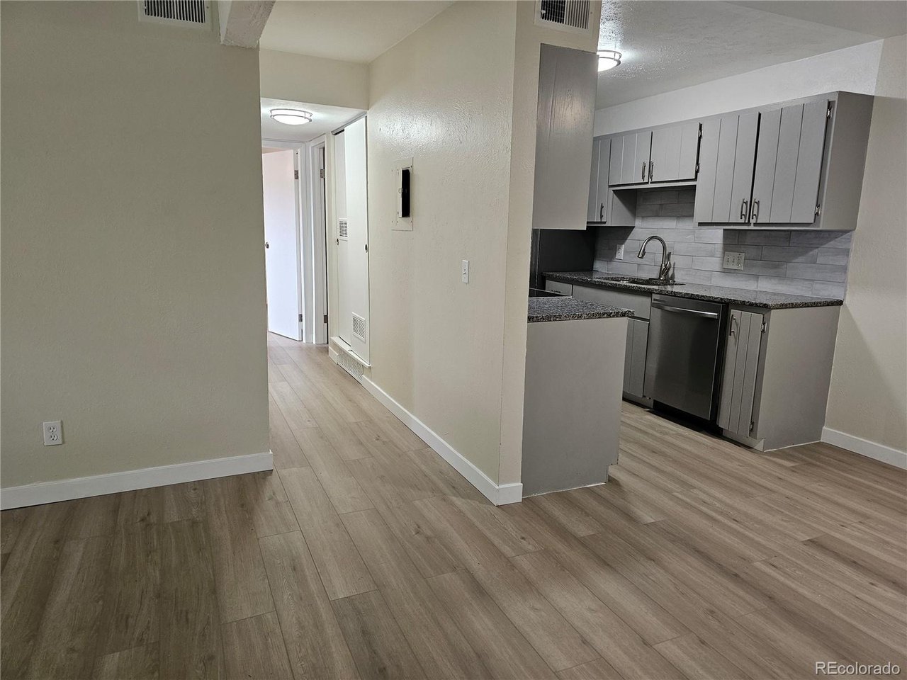 16259 West 10th Avenue, Unit K Golden, CO 80401 - Photo 7 of 24 a kitchen with stainless steel appliances granite countertop a stove a sink and a refrigerator
