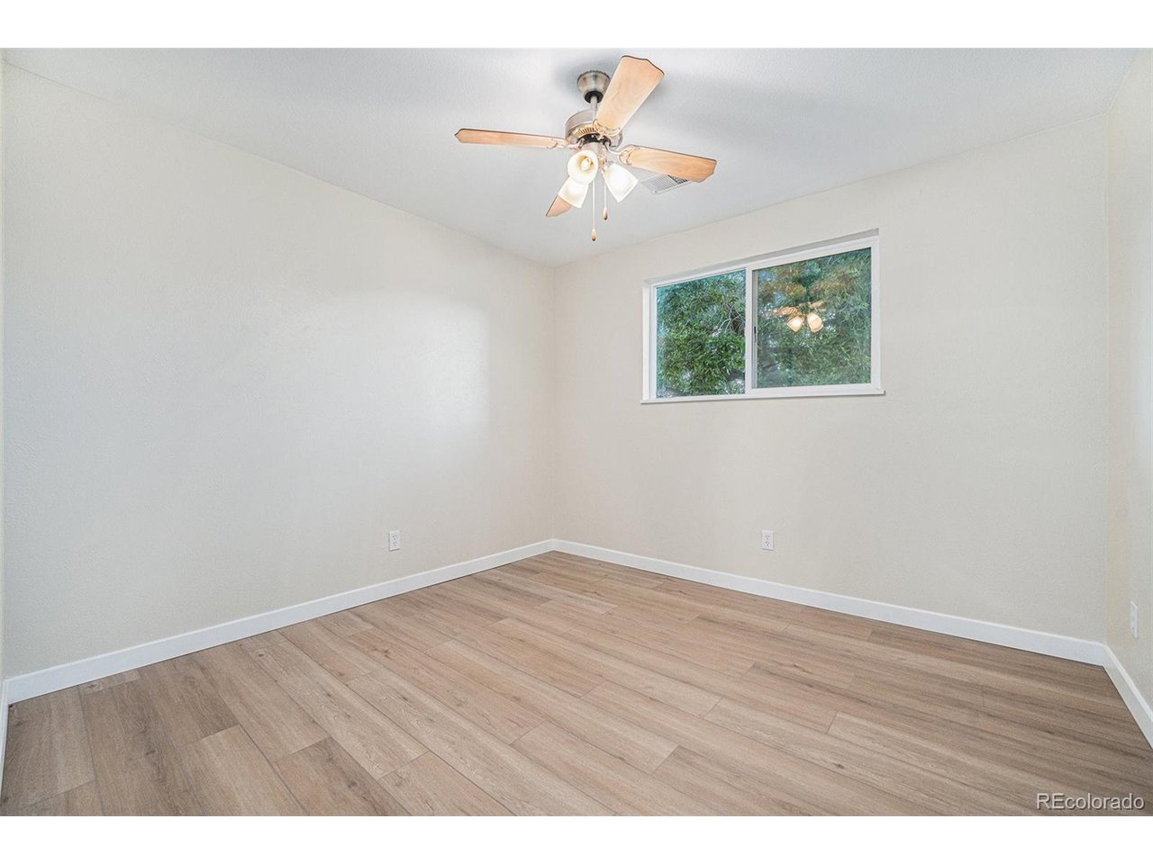 16259 West 10th Avenue, Unit K Golden, CO 80401 - Photo 8 of 24 a view of an empty room with wooden floor