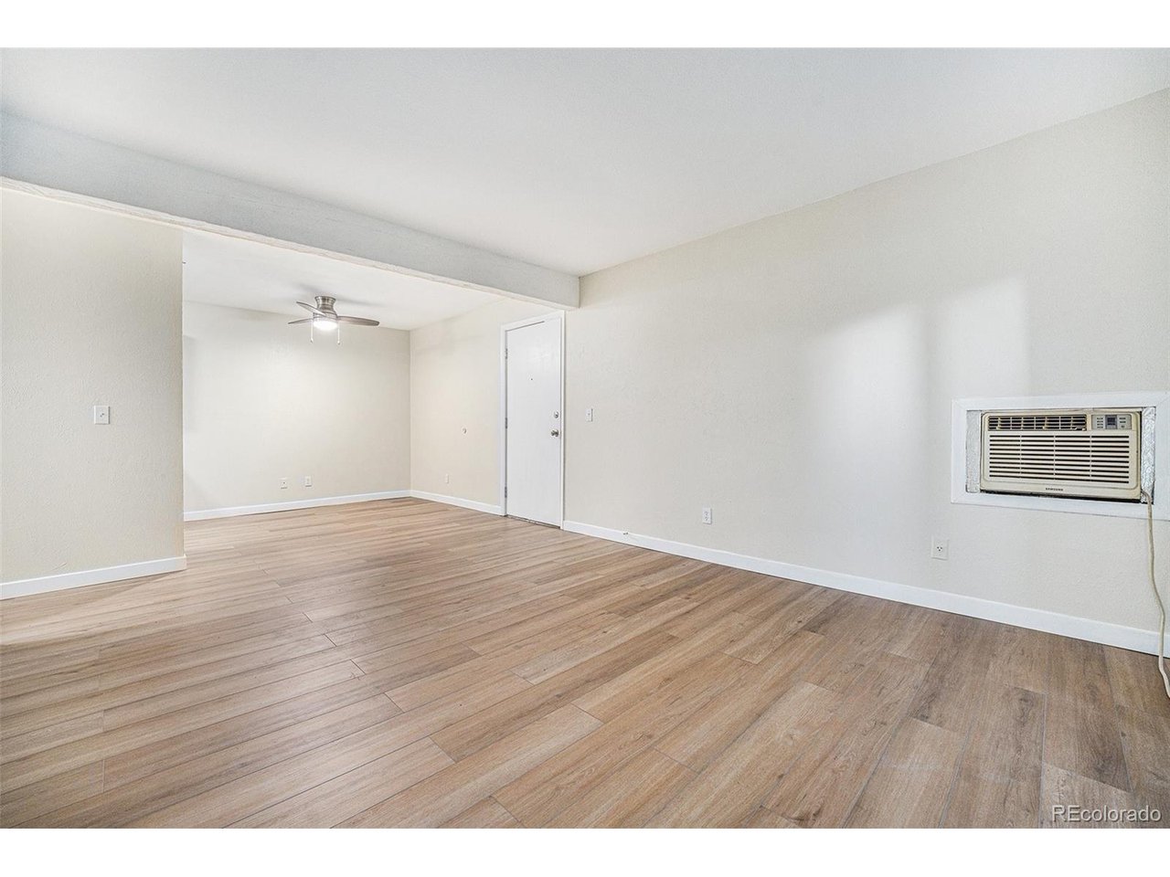 16259 West 10th Avenue, Unit K Golden, CO 80401 - Photo 9 of 24 a view of an empty room with wooden floor
