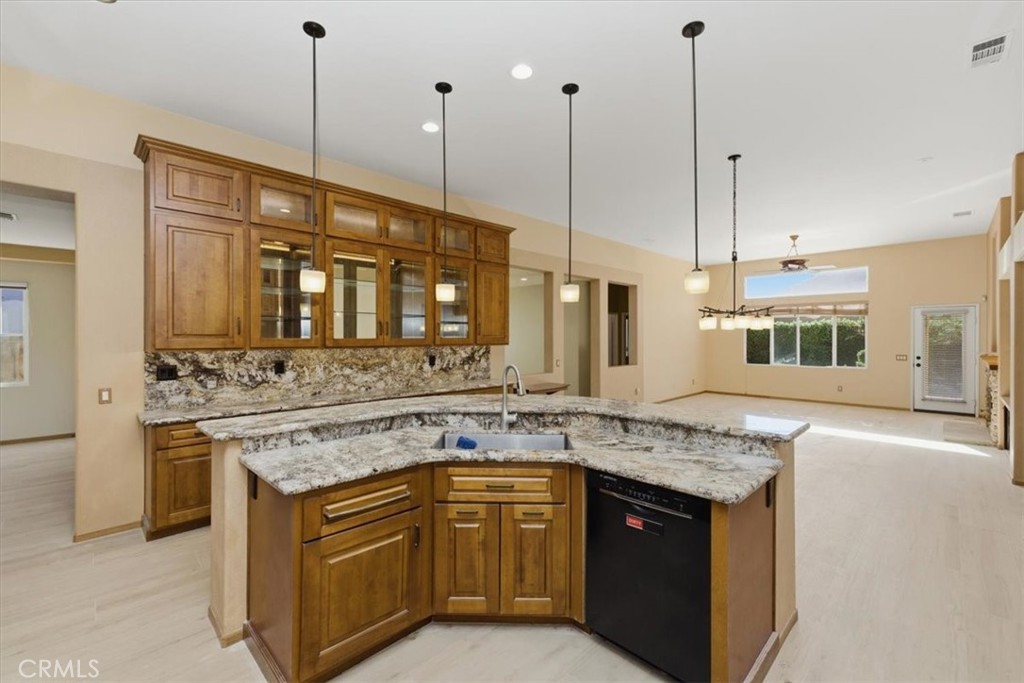 13747 Robinbrook Court Eastvale, CA 92880 - Photo 22 of 50 a kitchen with a sink stove and a sink