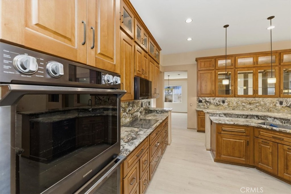 13747 Robinbrook Court Eastvale, CA 92880 - Photo 23 of 50 a kitchen with a stove and a sink