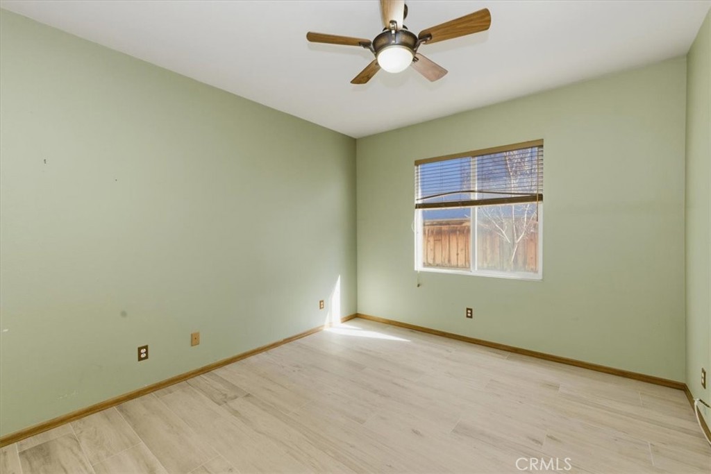 13747 Robinbrook Court Eastvale, CA 92880 - Photo 32 of 50 an empty room with windows and fan