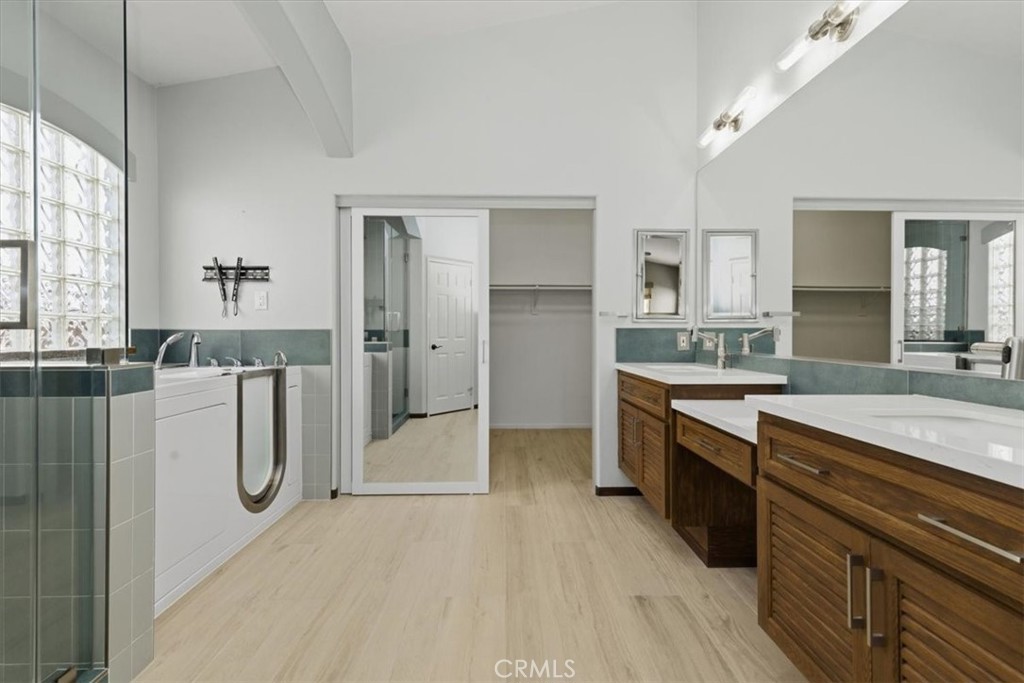 13747 Robinbrook Court Eastvale, CA 92880 - Photo 39 of 50 a large bathroom with a tub sink and mirror