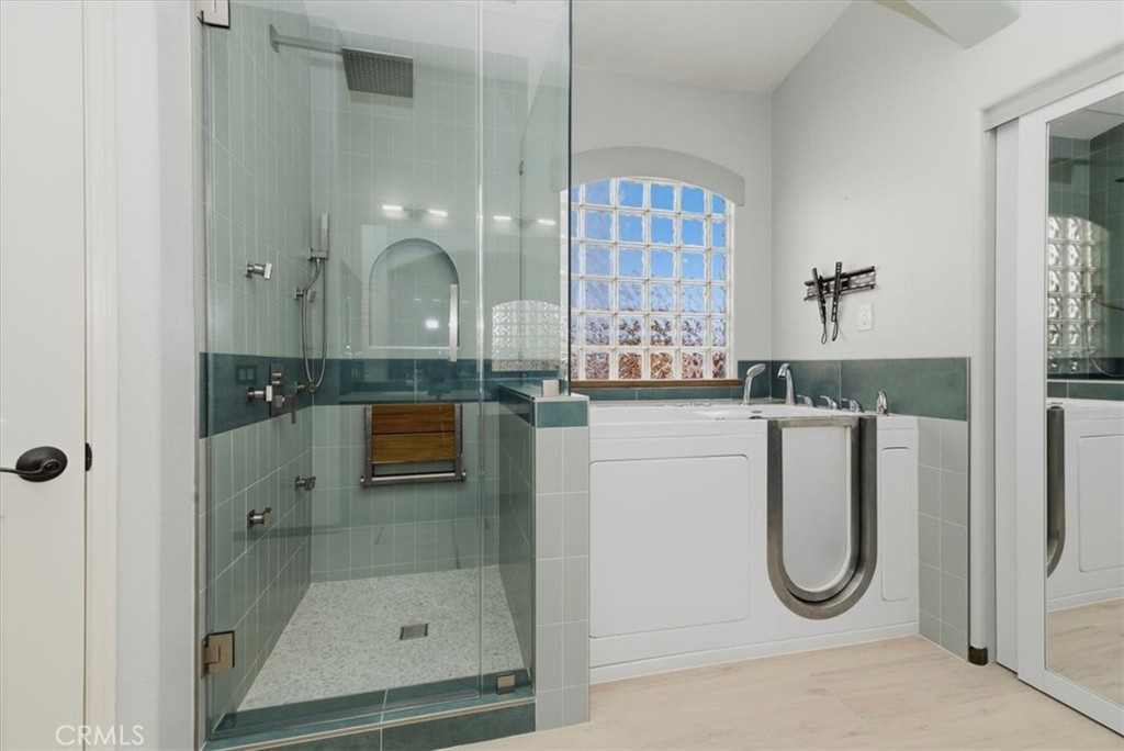 13747 Robinbrook Court Eastvale, CA 92880 - Photo 40 of 50 a bathroom with a granite countertop shower a mirror and a sink