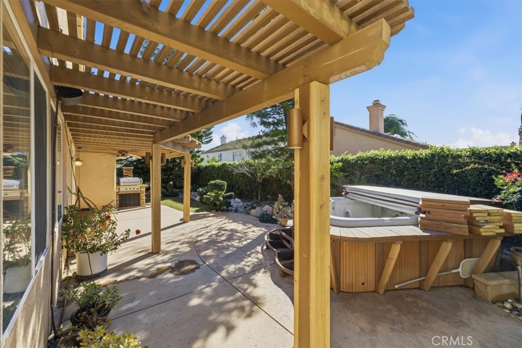 13747 Robinbrook Court Eastvale, CA 92880 - Photo 47 of 50 a view of a patio with table and chairs next to a yard