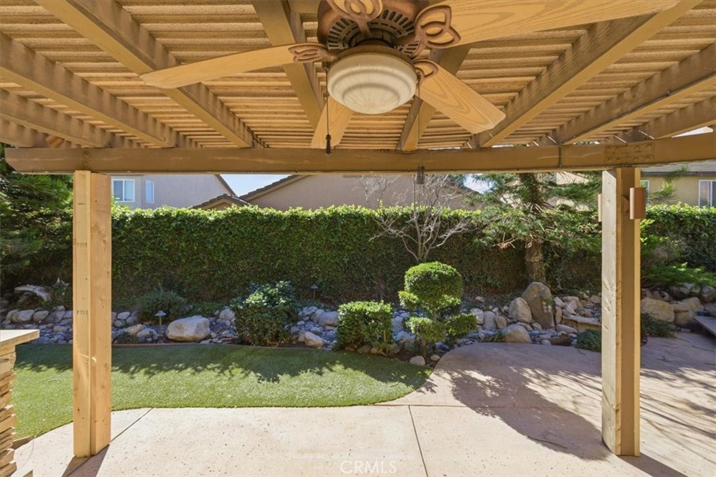 13747 Robinbrook Court Eastvale, CA 92880 - Photo 49 of 50 a view of a porch with a floor to ceiling window next to a yard