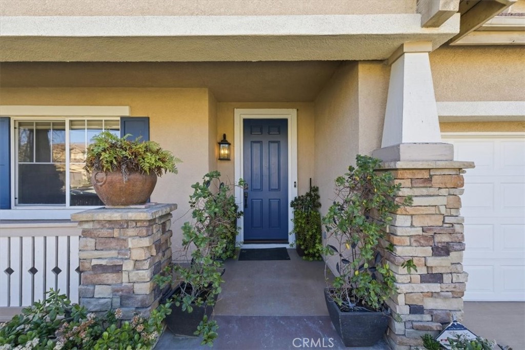 13747 Robinbrook Court Eastvale, CA 92880 - Photo 6 of 50 a front view of a house with potted plants