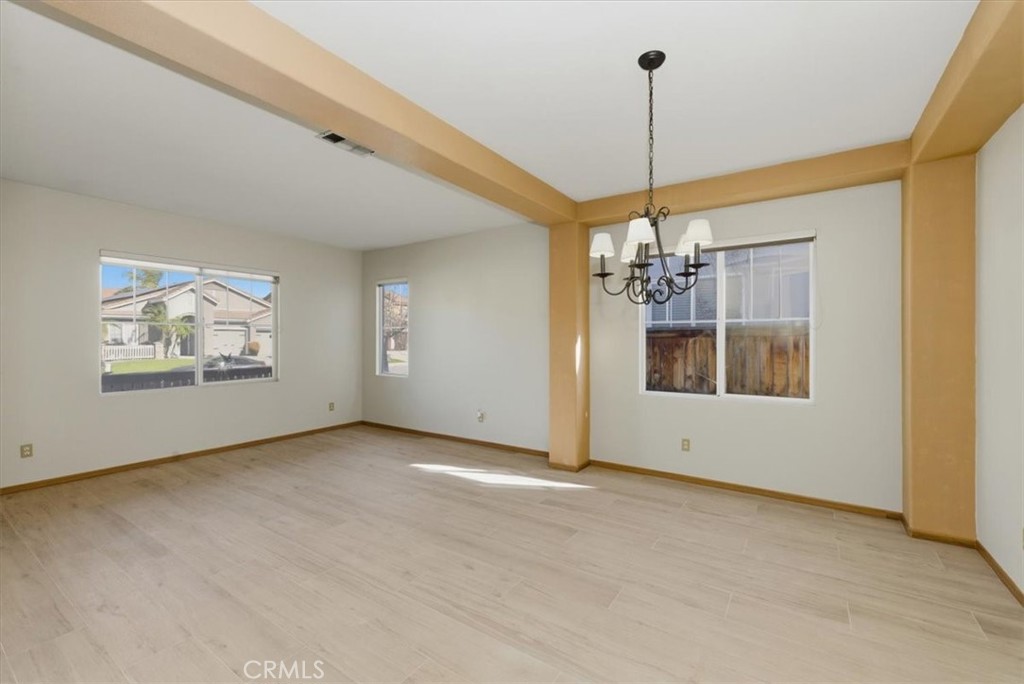 13747 Robinbrook Court Eastvale, CA 92880 - Photo 10 of 50 a view of a room with window wooden floor and windows
