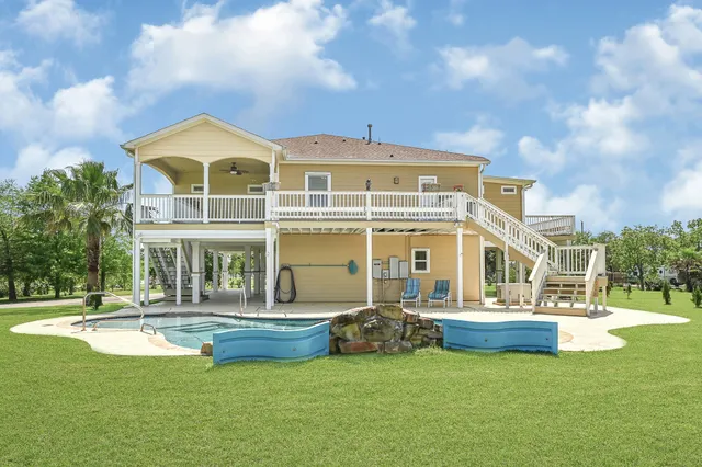 a front view of a house with swimming pool and porch
