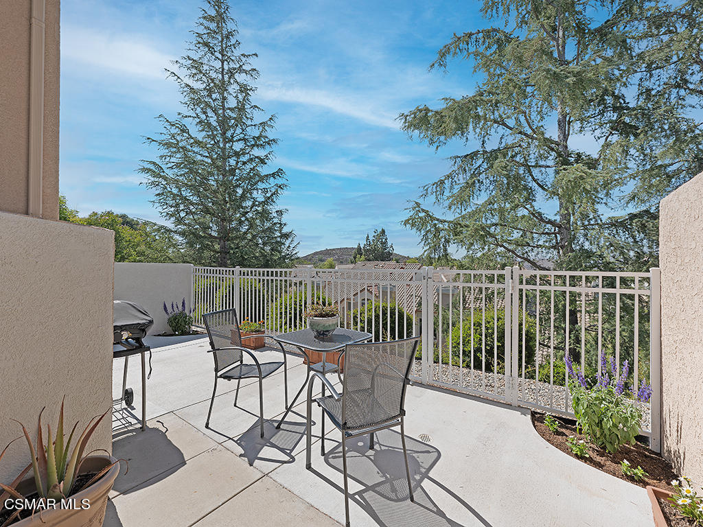 a view of a chairs and table in the patio