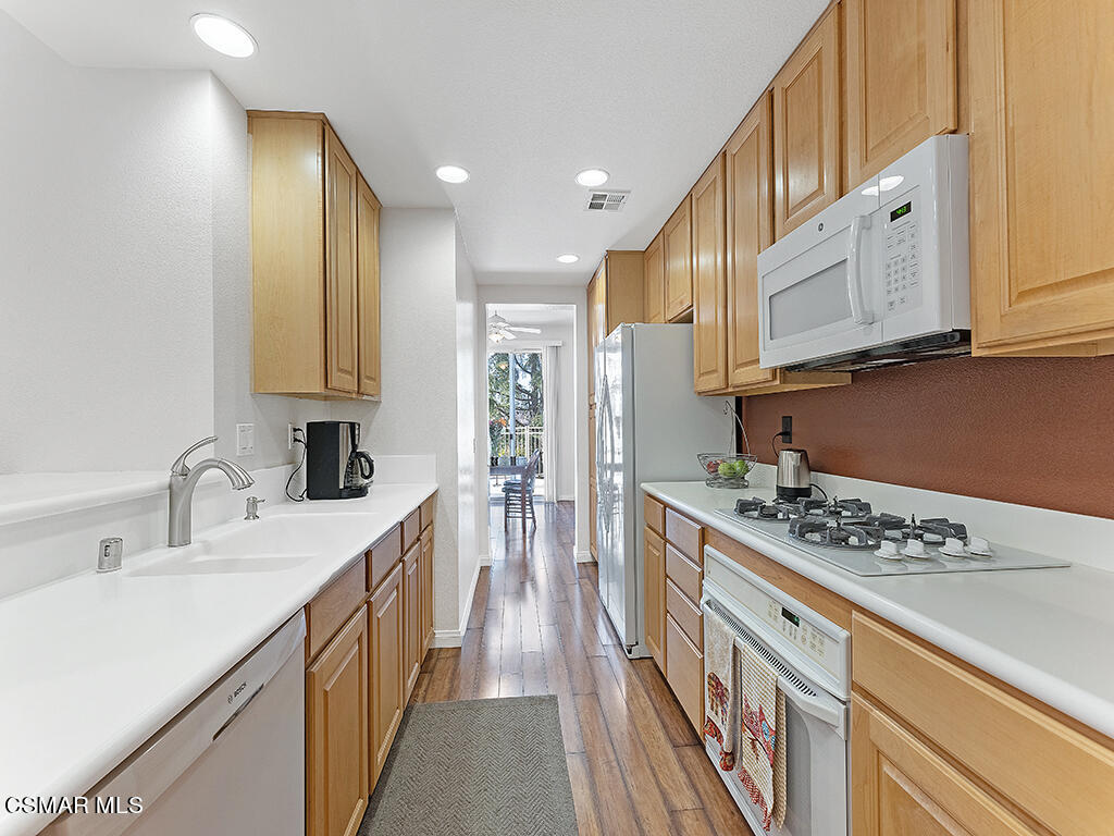 657 Cardinal Ridge Lane, Unit C Simi Valley, CA 93065 - Photo 22 of 53 a kitchen with stainless steel appliances kitchen island granite countertop a sink and cabinets
