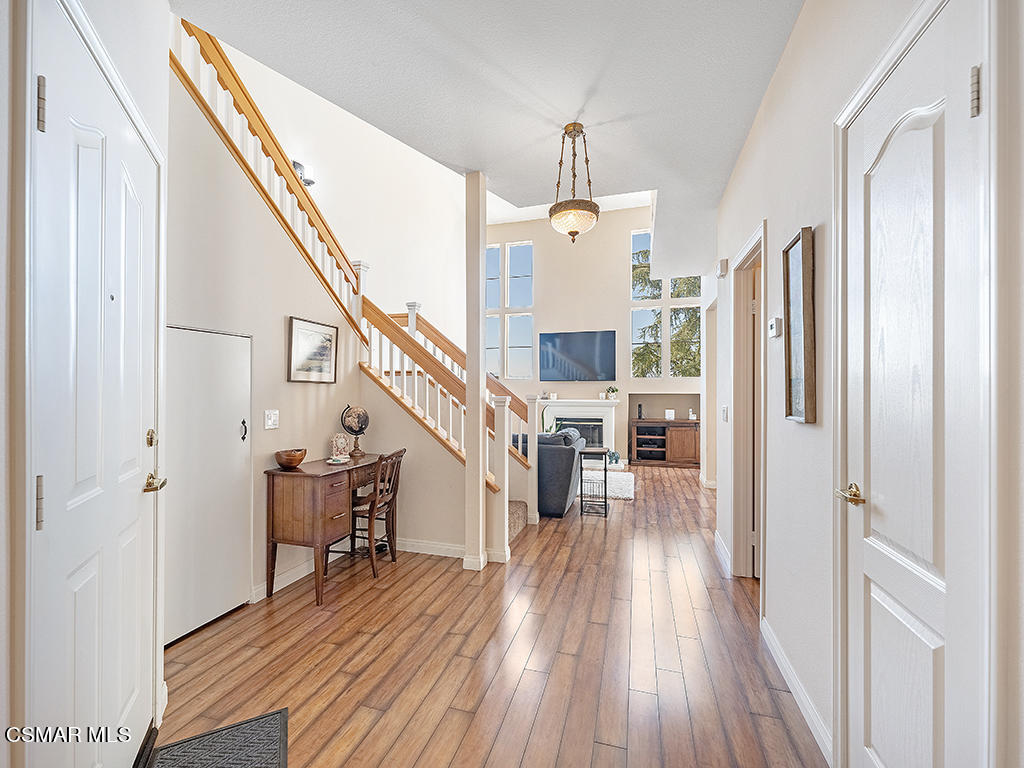 657 Cardinal Ridge Lane, Unit C Simi Valley, CA 93065 - Photo 9 of 53 a view of a hallway with wooden floor and staircase