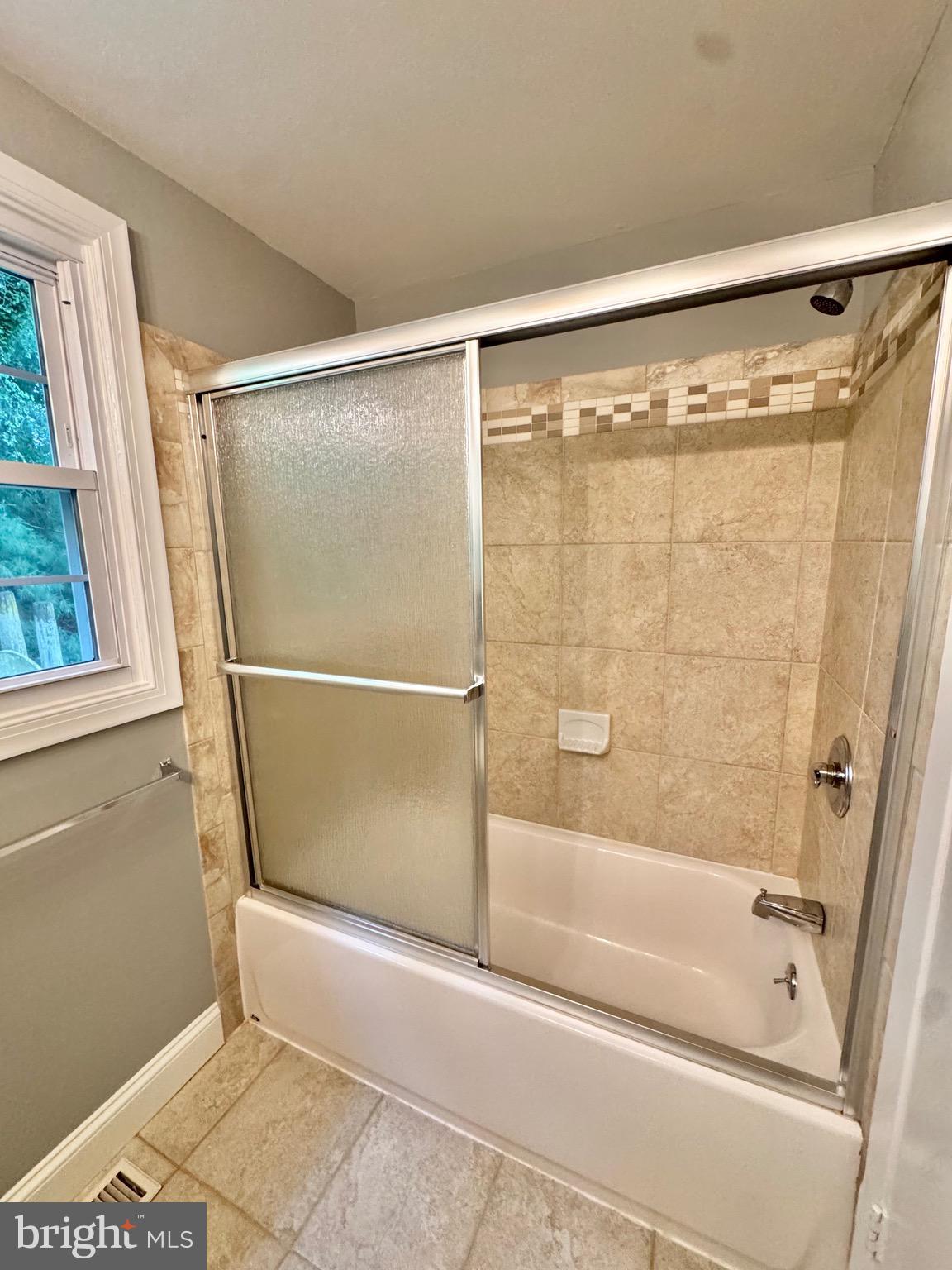 4908 Rocky Spring Lane Bowie, MD 20715 - Photo 31 of 36 a bathroom with a glass shower door