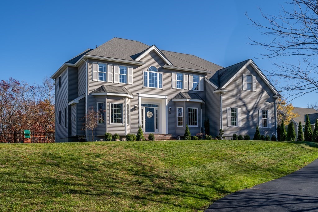 a front view of house with yard and green space