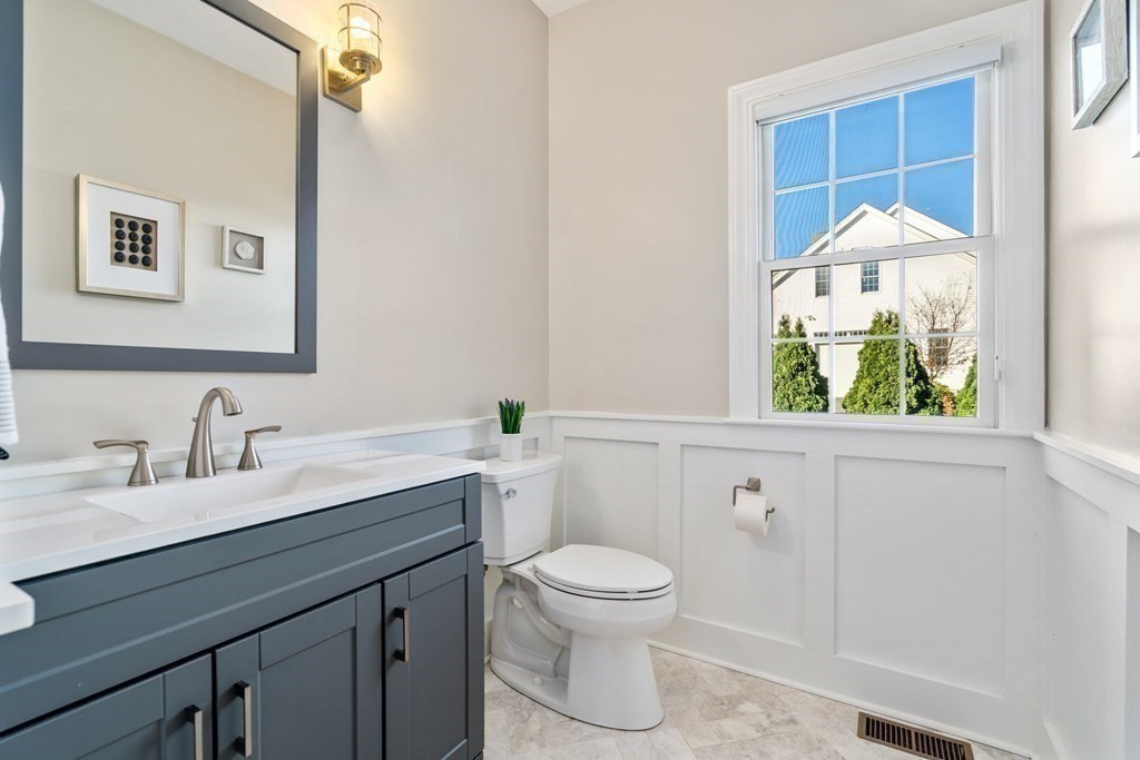 48 Mohawk Path Holliston, MA 01746 - Photo 16 of 41 a bathroom with a granite countertop sink a toilet and a window