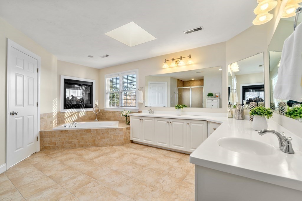 48 Mohawk Path Holliston, MA 01746 - Photo 20 of 41 a bathroom with a tub a sink and a mirror
