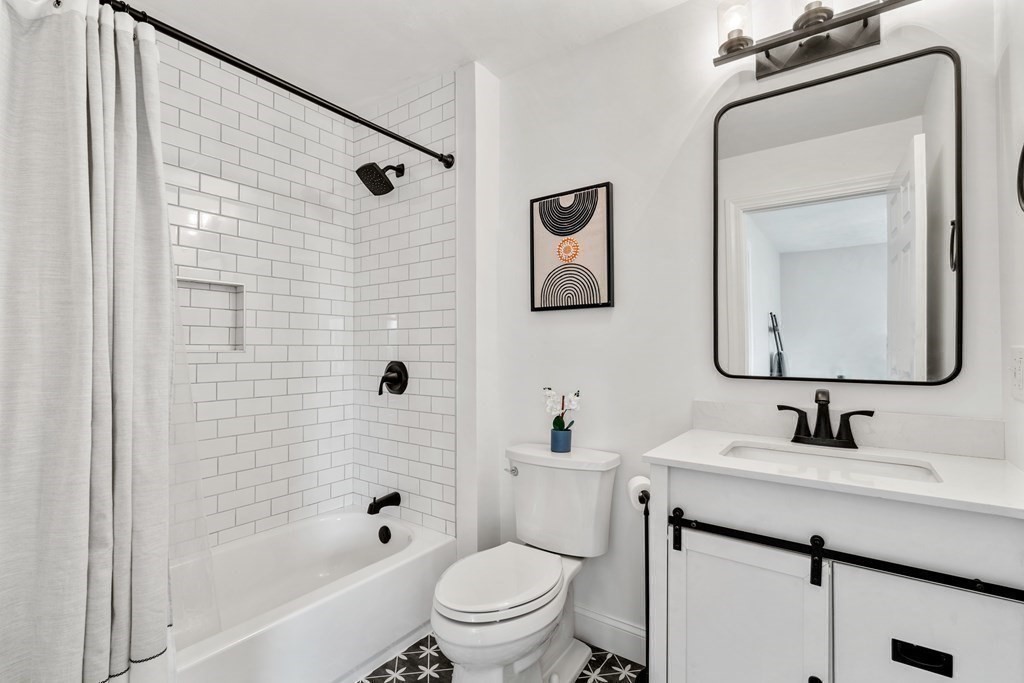48 Mohawk Path Holliston, MA 01746 - Photo 23 of 41 a bathroom with a toilet sink vanity tub and mirror