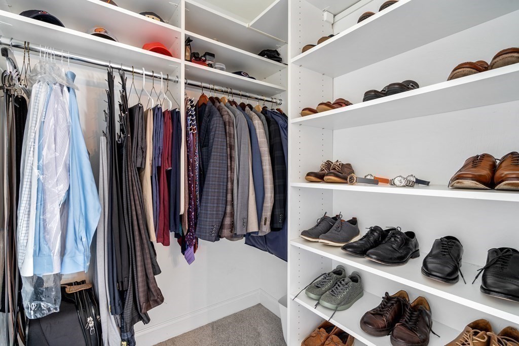 48 Mohawk Path Holliston, MA 01746 - Photo 24 of 41 a view of walk in closet with clothes and shoes