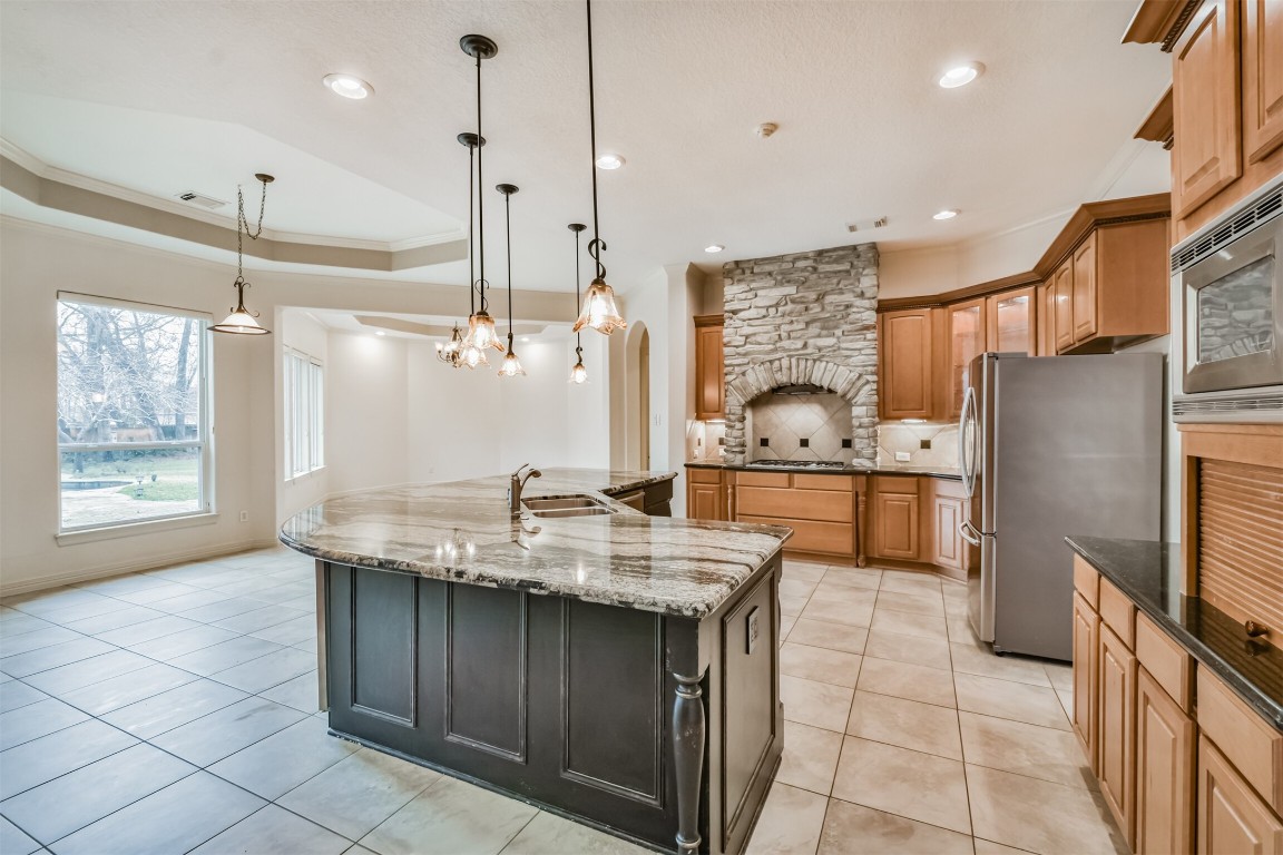 2 Sagestone Conroe, TX 77304 - Photo 11 of 50 a kitchen with granite countertop a sink a counter top space appliances and cabinets