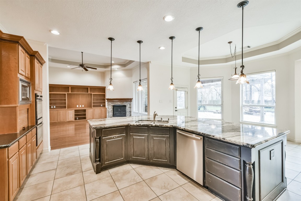 2 Sagestone Conroe, TX 77304 - Photo 13 of 50 a kitchen with stainless steel appliances granite countertop a sink and stove