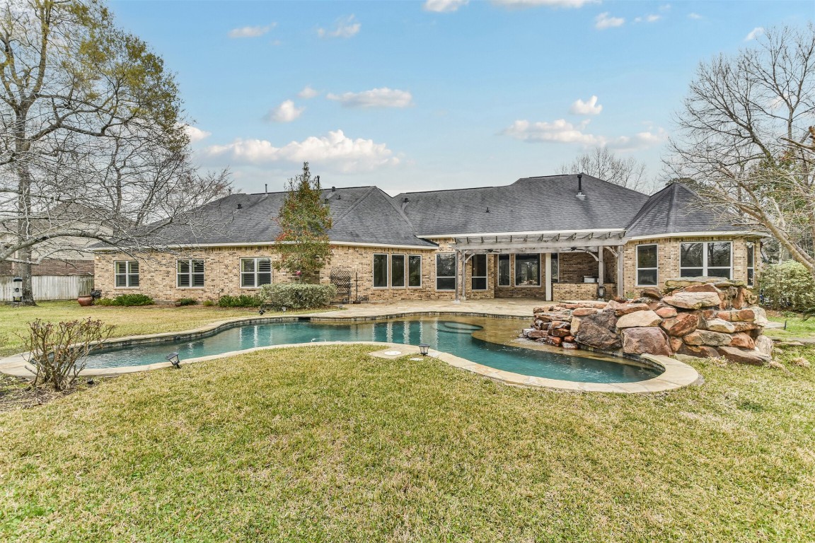 2 Sagestone Conroe, TX 77304 - Photo 2 of 50 a front view of a house with swimming pool and a yard