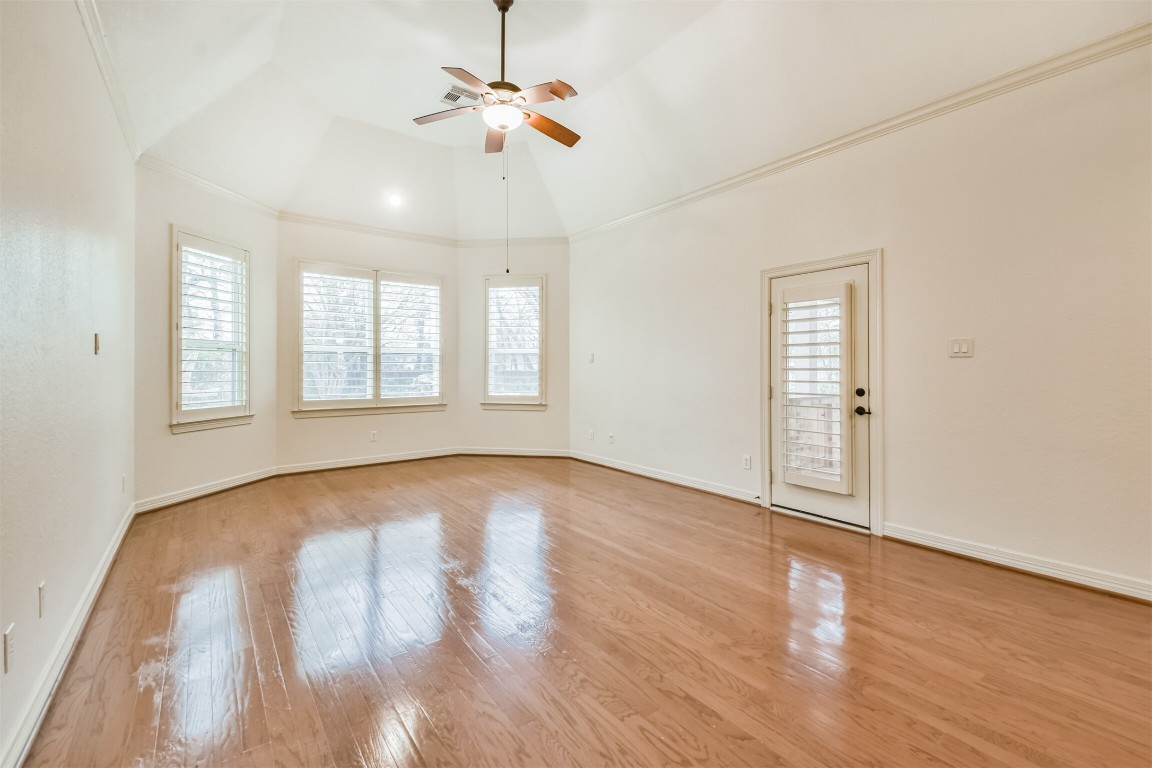 2 Sagestone Conroe, TX 77304 - Photo 25 of 50 an empty room with wooden floor chandelier fan and windows