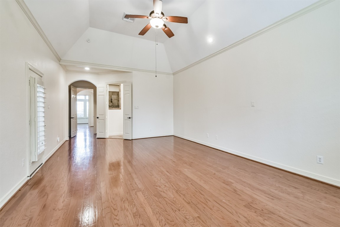 2 Sagestone Conroe, TX 77304 - Photo 26 of 50 a view of a big room with wooden floor a ceiling fan and windows