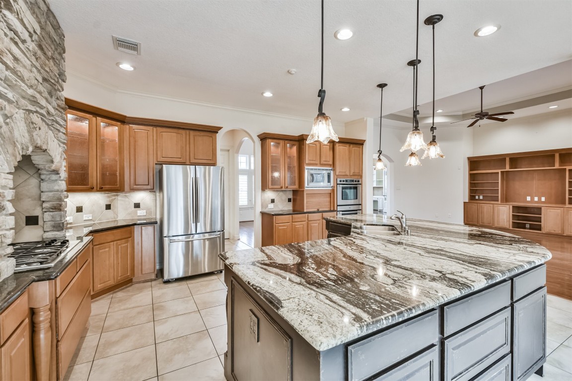 2 Sagestone Conroe, TX 77304 - Photo 4 of 50 a kitchen with stainless steel appliances granite countertop sink stove and refrigerator