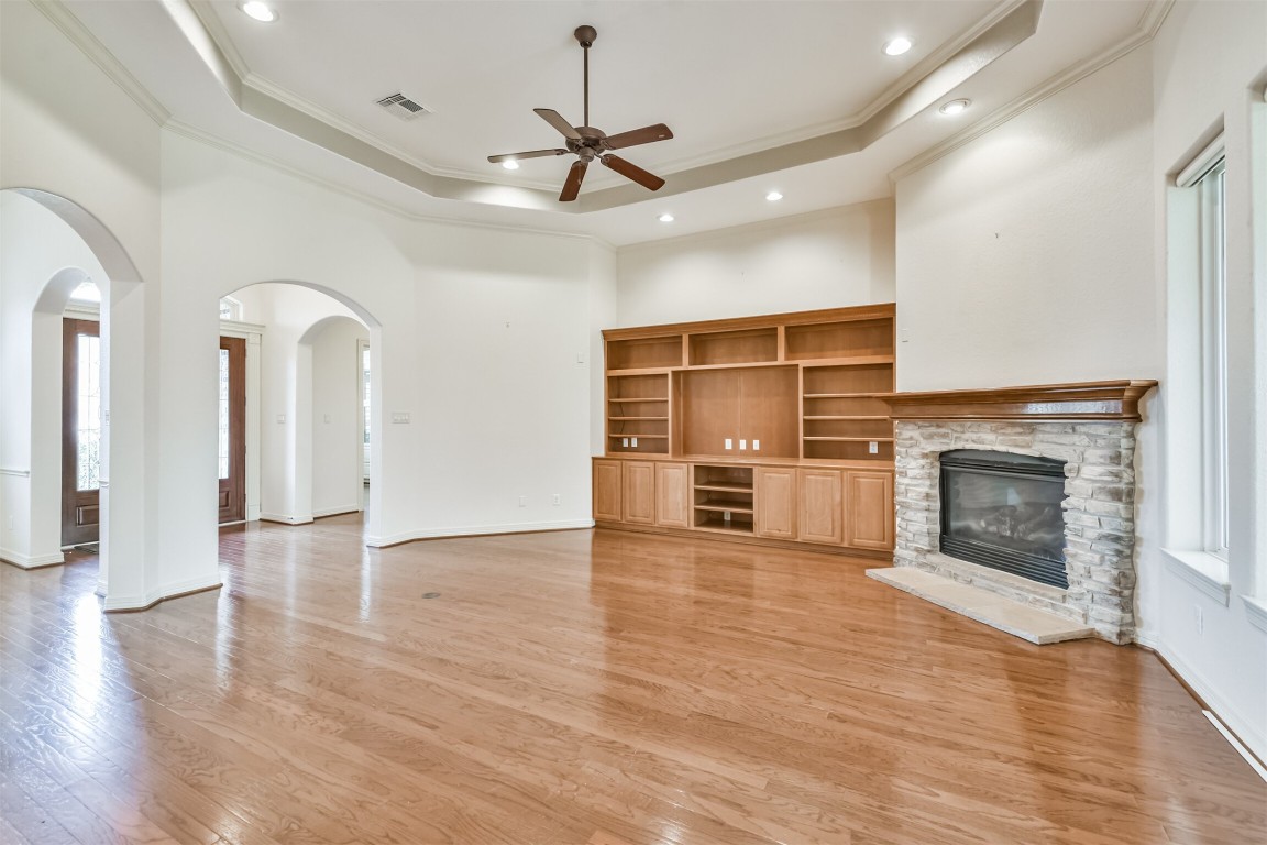 2 Sagestone Conroe, TX 77304 - Photo 10 of 50 an empty room with wooden floor fireplace and windows