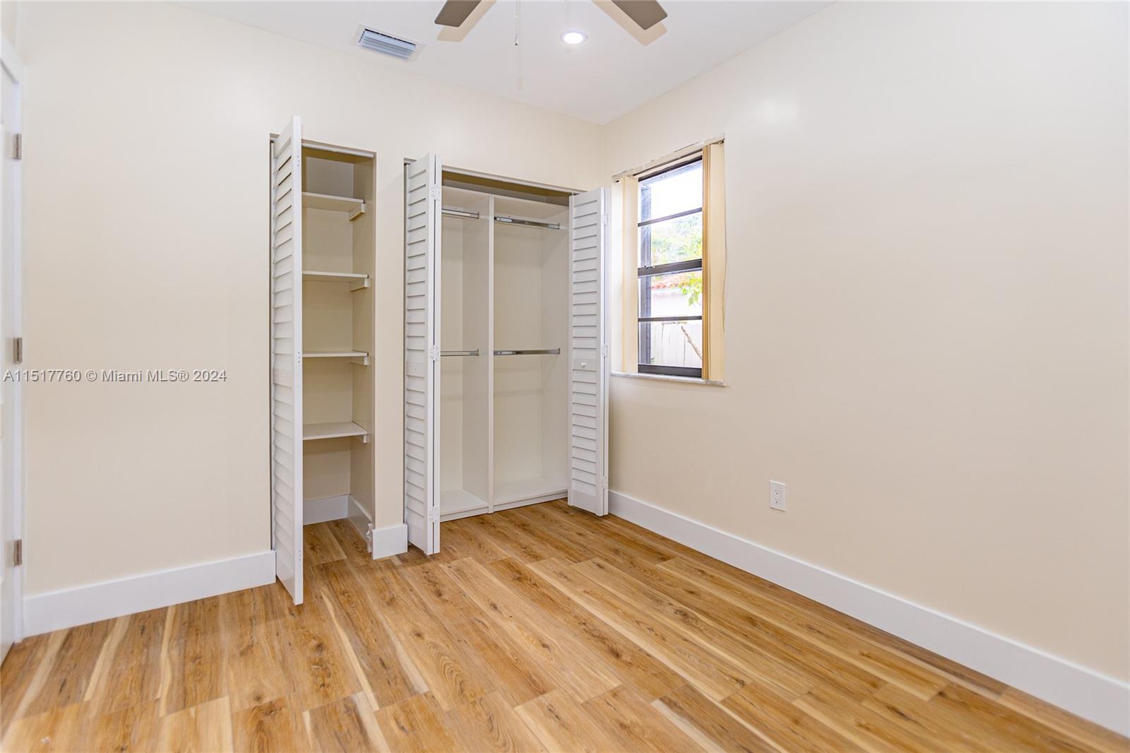 Flagami Miami, FL 33134 - Photo 26 of 44 an empty room with wooden floor cabinet and windows